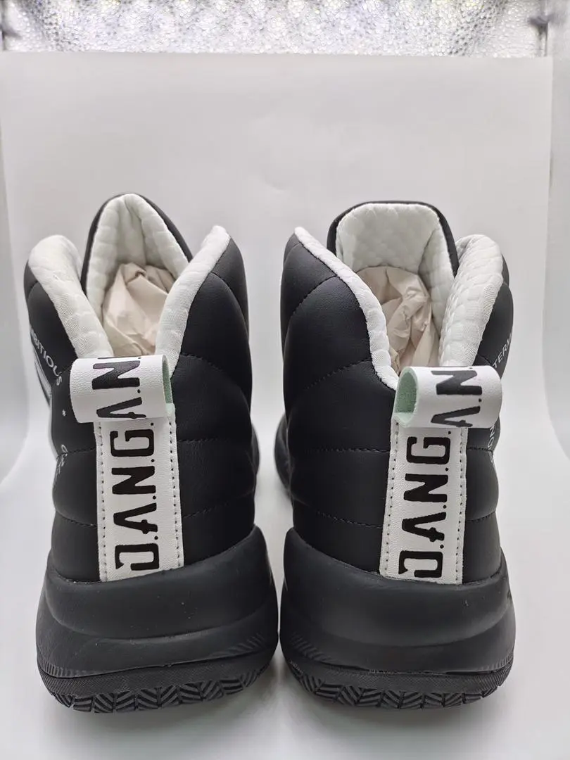 Back view of black and white sneakers with 'DANG' text on the back.